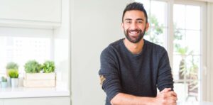 Cover image: PhD student smiles after submitting his dissertation